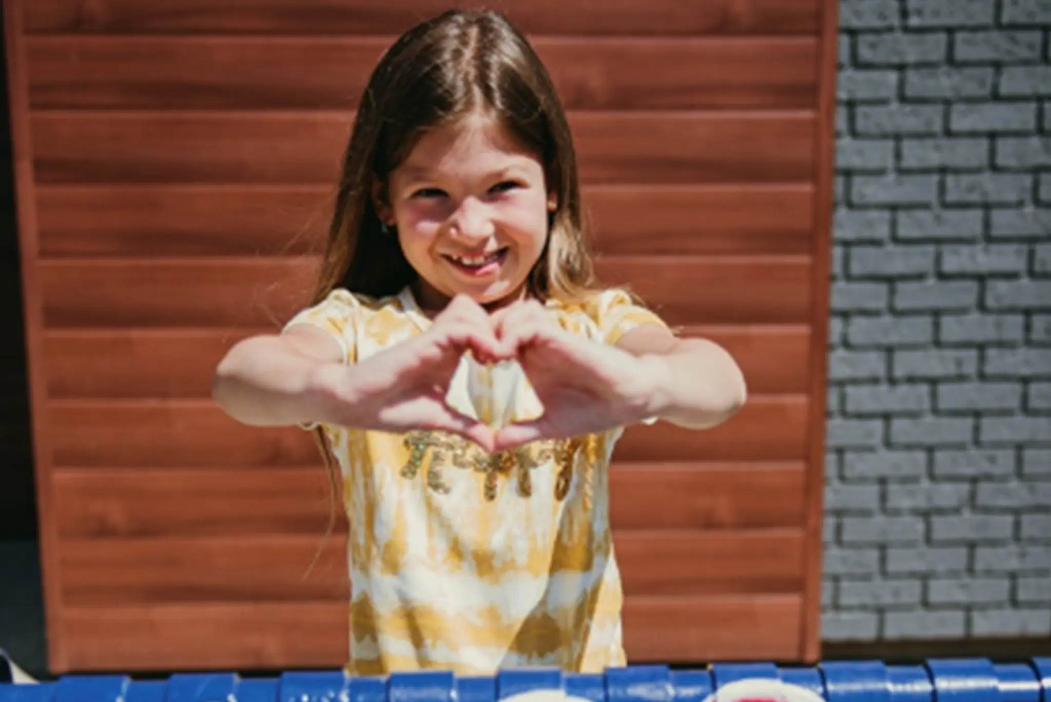 Girl showing with heart sign Girl showing with heart sign